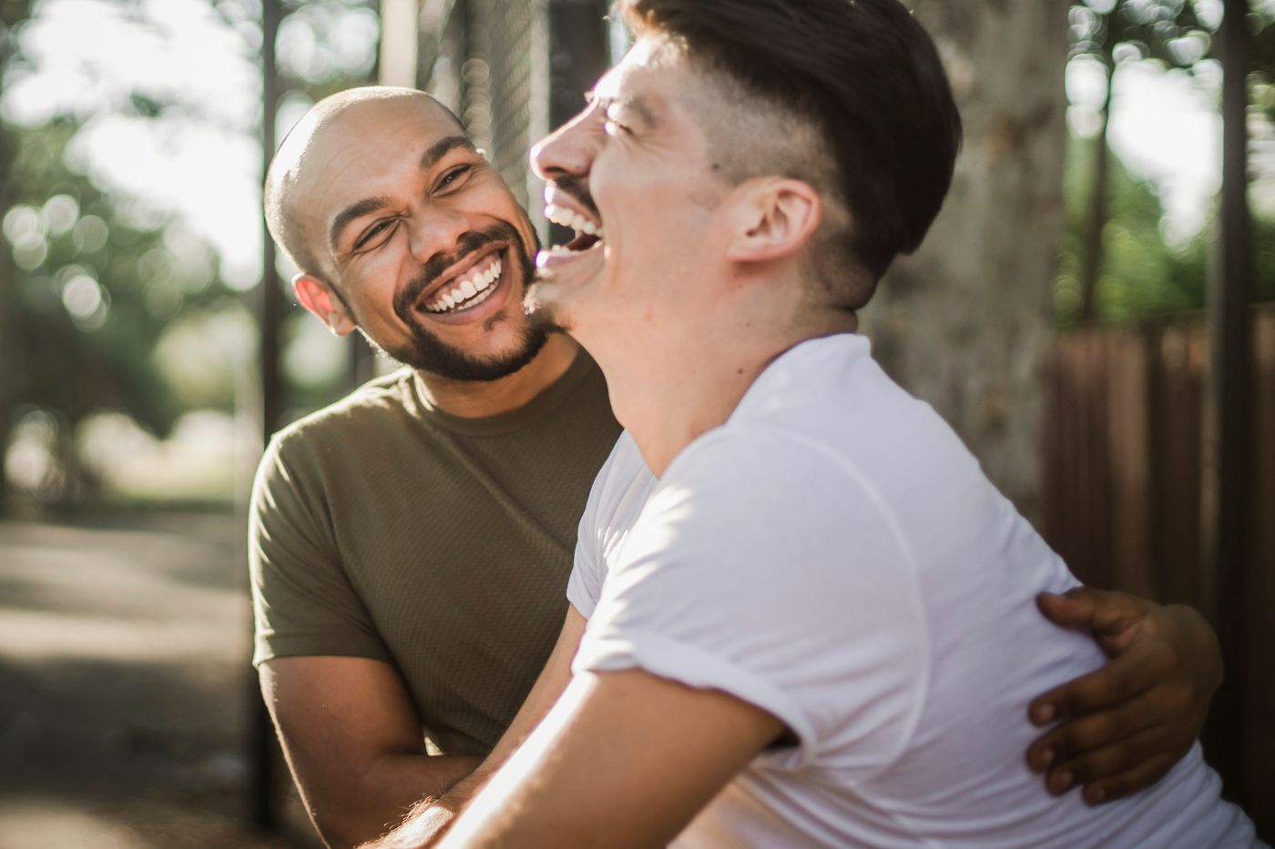 Two people laughing together outdoors