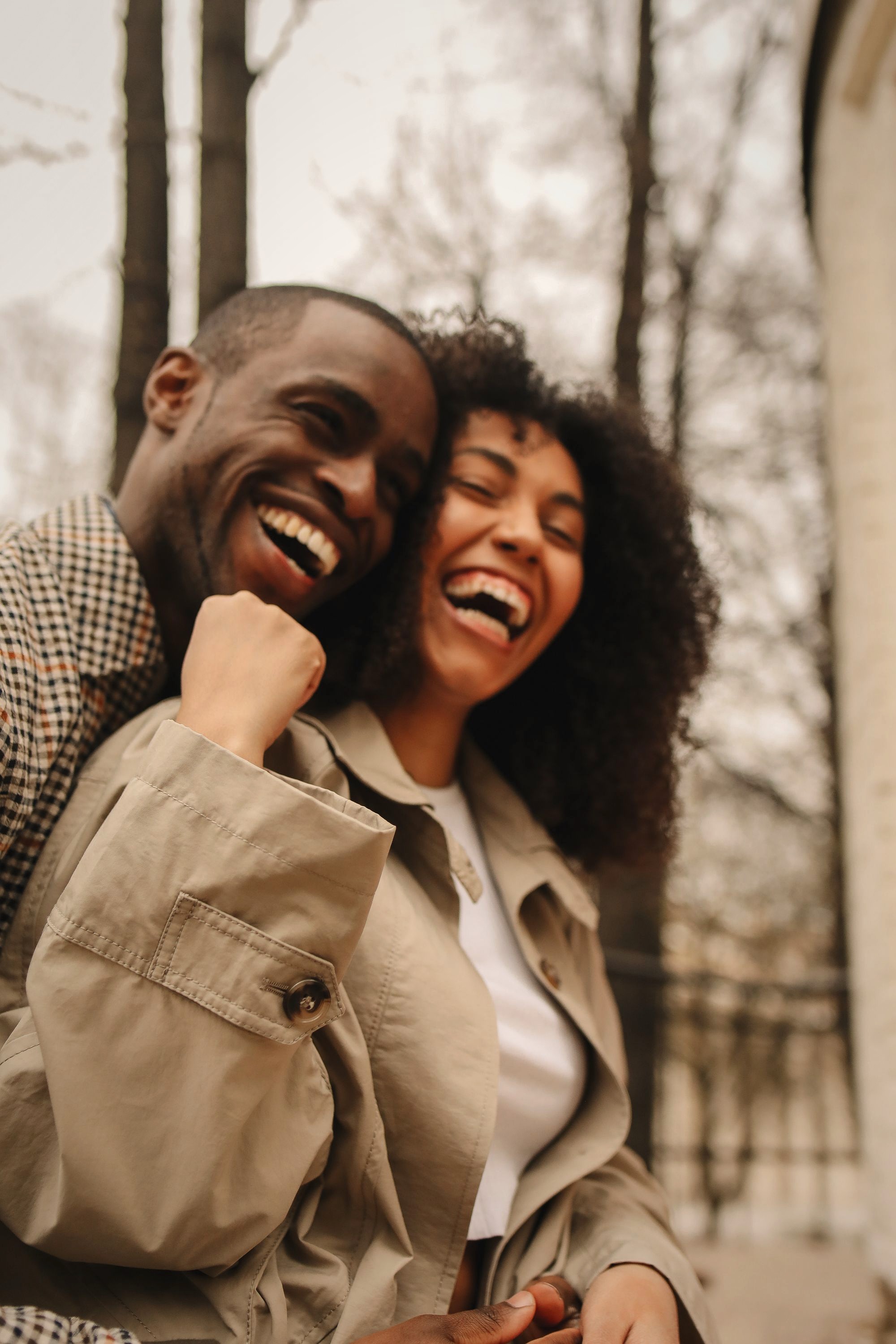 Two people laughing together outdoors